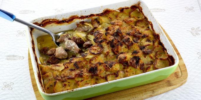 Pork with potatoes, cream and rosemary in the oven