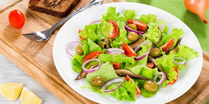Simple salad with sprats, tomatoes and olives