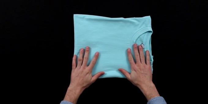 Fold the T-shirt so that the front part of the covered projecting sleeve