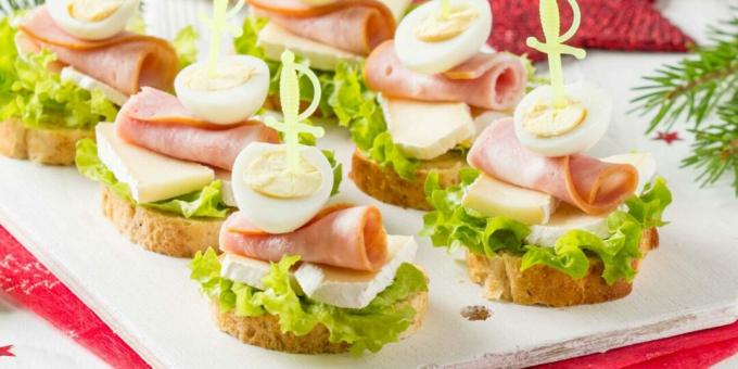 Canape with cheese, ham and quail eggs