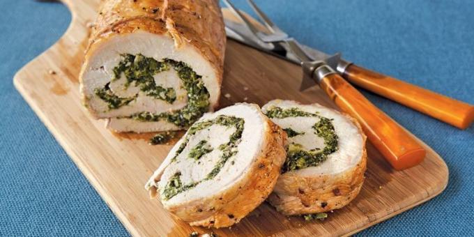 Pork in the oven: Pork roulade with spinach and cheese on a bed of vegetables