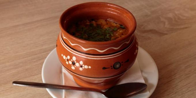 Fish soup with olives in a pot