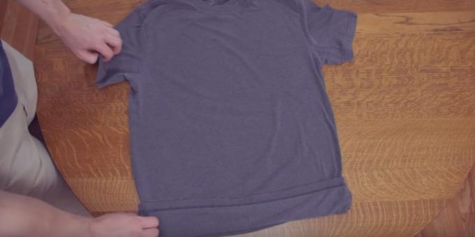 Lay the T-shirt and slightly bend the bottom edge