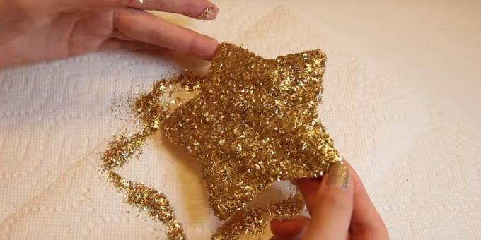 Cover the star with glue, sprinkle glitter and shake off excess