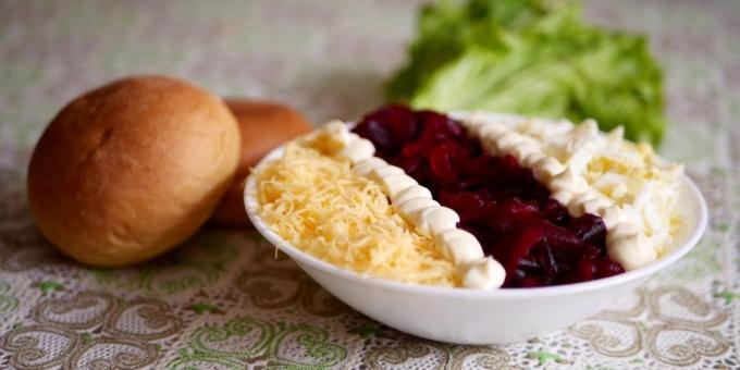 Salad of boiled beets with cheese, eggs and prunes
