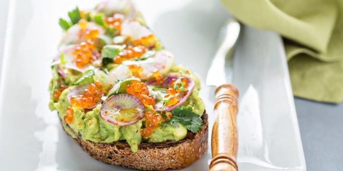 Sandwiches with red caviar, avocado and radish