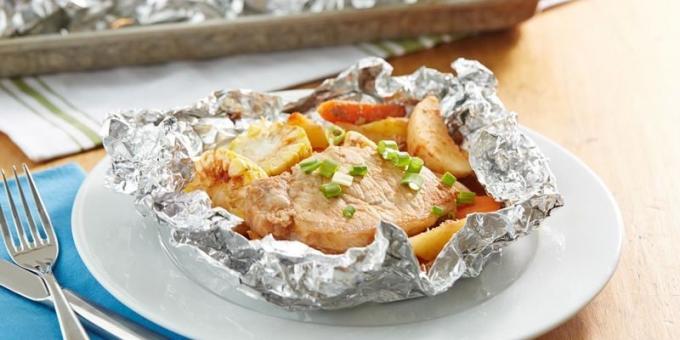 Pork with potatoes and corn in foil in the oven