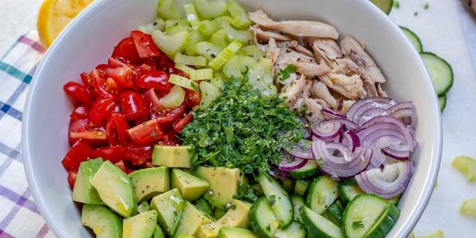 Salad with celery, chicken, avocado, tomato and cucumber